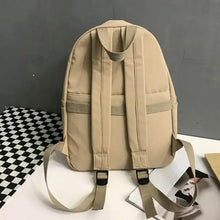 Light tan cotton backpack bag with adjustable straps and zippered compartments