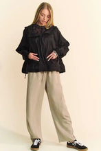 Black puffer jacket with ruffles and hood over Dani drawstring wide leg sweatpants