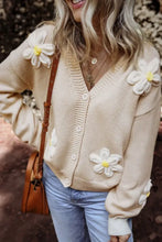 Beige floral cardigan sweater with white and yellow flowers, button closure, long sleeves