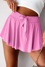 Lavender pleated tennis skirt with bow tie waistband and high-waisted shorts
