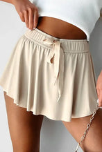 Beige pleated tennis skirt with drawstring waistband and chain detail from high-waisted shorts collection