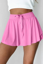 Pink pleated tennis skirt with elastic waistband and drawstring detail