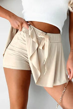 Beige high-waisted paperbag shorts with ruffles from pleated tennis skirt collection