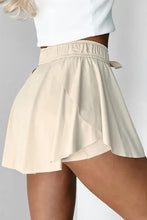 Beige high-waisted shorts with bow detail from pleated tennis skirt collection