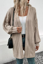 Beige oversized knit cardigan with balloon sleeve length and belt