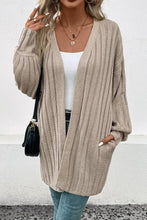Beige oversized knit cardigan with balloon sleeve length and v-neck
