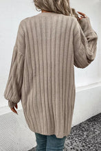 Beige oversized knit cardigan with balloon sleeve length and V-neck