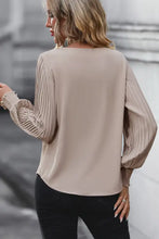 Beige pleated lantern sleeve blouse with V-neck and lace cuffs