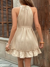 Beige swiss dot halter neck dress with ruffled hem and button detail