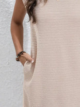Cream-colored textured sleeveless dress with high neckline and pockets