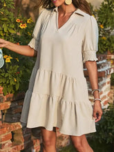 Beige tiered dress with puff sleeves and smocked details