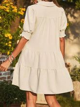 Cream tiered dress in beige with ruffled sleeves and pockets