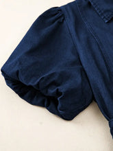 Dark blue denim midi dress fabric with soft wrinkled texture and gathered puff sleeve detail in midi denim dress