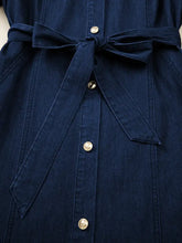 Dark blue midi denim dress with self-tie belt and gold-tone buttons in a belted button-down midi denim dress style