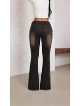 Belted high waist flare jeans in black denim with faded wash and frayed hem for a stylish casual look