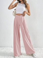 Soft pink wide leg pants with a flattering ruched front and smooth flowing fabric in high-waisted design