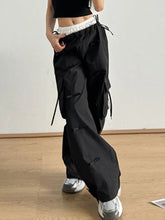 Black cargo pants with bow elastic waist and multiple pockets featuring a white elastic waist cargo design and relaxed fit