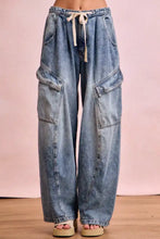 Light-wash denim baggy barrel jeans with wide legs cargo pockets and beige drawstring waistband for casual wear