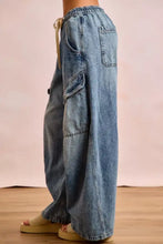 Light-wash denim bi bi baggy barrel jeans with cargo pockets elastic waistband and beige drawstring