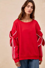 Red fleece blend sweatshirt with white ribbon bow details on sleeves ideal for stylish layering and pairing tips