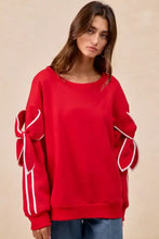 Red BiBi bow detail sleeves fleece blend sweatshirt with oversized fit and white ribbon bow details on sleeves pairing tips included