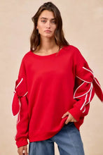 Red oversized fleece blend sweatshirt with white piping and ruffled bow detail sleeves perfect for casual pairing tips