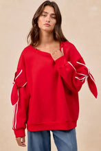 Red oversized fleece blend sweatshirt with white ribbed tie details on sleeves pairing tips included