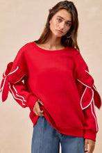 Red fleece blend BiBi oversized sweatshirt with white piping and large bow detail sleeves perfect for stylish pairing tips