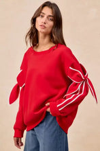 Red BiBi bow detail sleeves fleece blend sweatshirt with white ribbon ties, ideal for cozy winter pairing tips