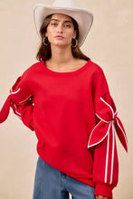 Red oversized fleece blend sweatshirt with white ribbon bows at cuffs featuring stylish pairing tips