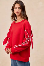 Red fleece blend BiBi bow detail sleeves sweatshirt with white ribbon bows at cuffs, ideal for stylish layering and pairing tips