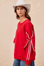 Red fleece blend BiBi bow detail sleeves sweatshirt with white ribbon bow detail on the sleeve perfect for layering and pairing tips