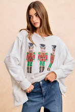 White oversized sweatshirt with sequin nutcrackers embroidery in red green and gold by BiBi for Christmas