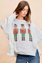 White oversized sweatshirt with sequin nutcrackers embroidery in red green and gold by BiBi Christmas