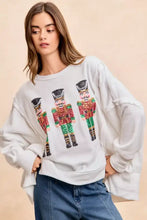 White oversized sweatshirt with sequin nutcrackers embroidery in red green and gold by BiBi for christmas wear