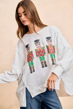 White oversized sweatshirt with sequin nutcrackers embroidery in red green and gold from BiBi Christmas collection