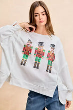 White oversized sweatshirt with sequin nutcrackers embroidery in red green and gold by bibi for christmas wear
