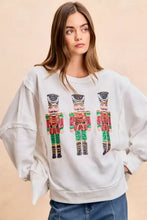 White oversized sweatshirt with sequin nutcrackers embroidery in red green and gold by bibi christmas collection