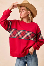 Red oversized sweatshirt with plaid block pattern across chest and sleeves by bibi christmas theme collection