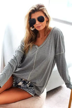 Woman in BiBi contrast stitching V-neck long sleeve T-shirt, denim shorts, aviators