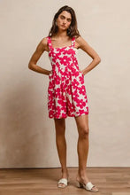 Vibrant pink floral print BiBi romper with square neckline and pockets