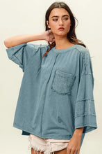 Model in BiBi High-Low Washed T-Shirt, faded teal with textured pocket