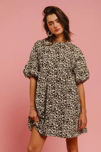 Women wearing a bi bi leopard denim dress with short ruffled sleeves and relaxed fit featuring back contrast tie detail