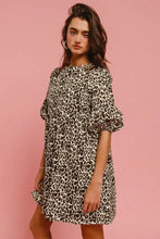 Women wearing a short-sleeved leopard denim dress with relaxed fit puff sleeves and back contrast tie detail