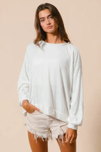 A soft off-white oversized BiBi loop terry pullover with relaxed fit long sleeves and distinctive cut edge band detailing