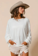 A soft off-white BiBi loop terry pull over with cut edge band features a relaxed fit and long sleeves with rolled cuffs