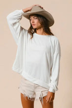 White oversized long-sleeve sweatshirt in soft loop terry fabric with relaxed fit and cut edge band detailing