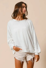 White oversized long-sleeve loop terry sweatshirt with relaxed fit ribbed cuffs and cut edge band detailing