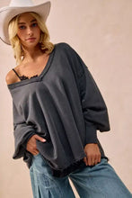 Dark gray bi bi mineral washed french terry oversized sweatshirt with loose silhouette and frayed hem paired with white sneakers