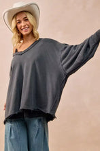 BiBi mineral washed french terry oversized sweatshirt in dark gray with off the shoulder frayed edges paired with white sneakers